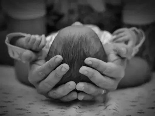 baby head in hands